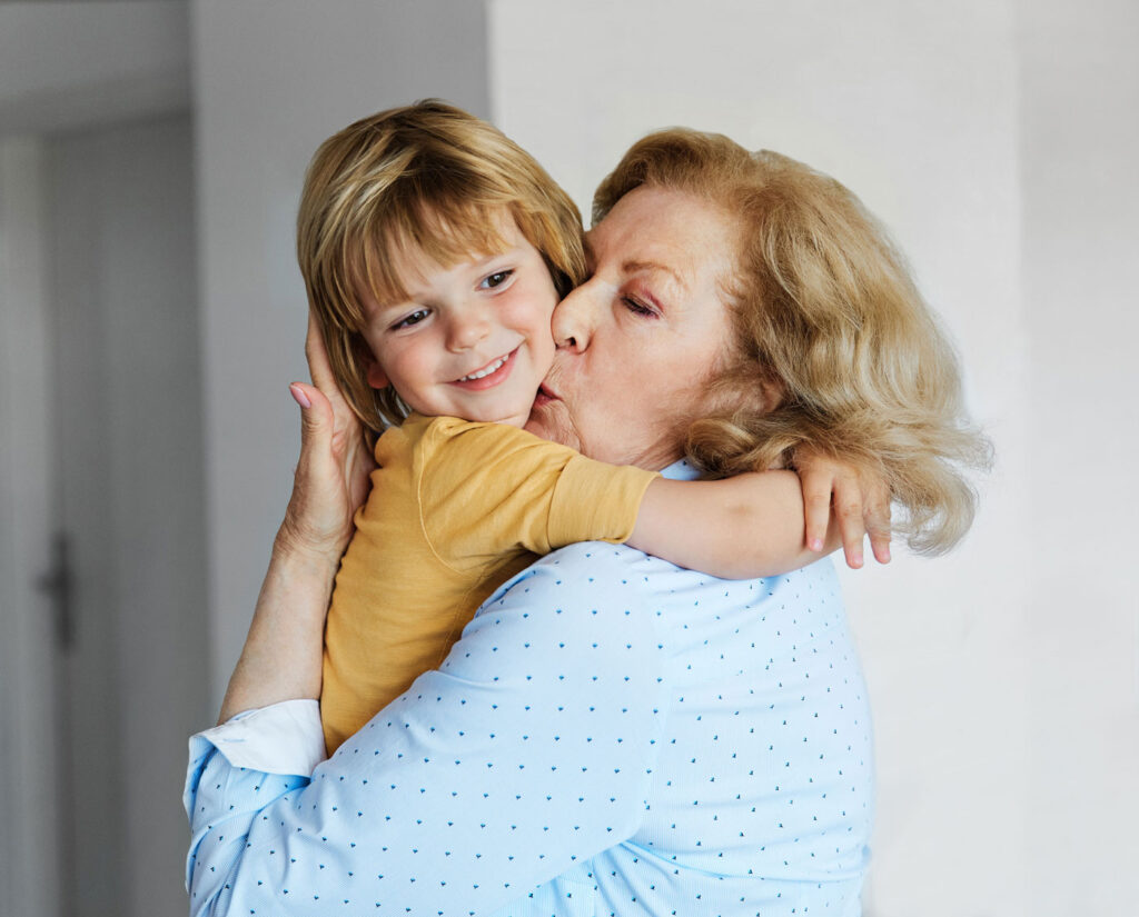 woman and child hugging inside senior living apartment